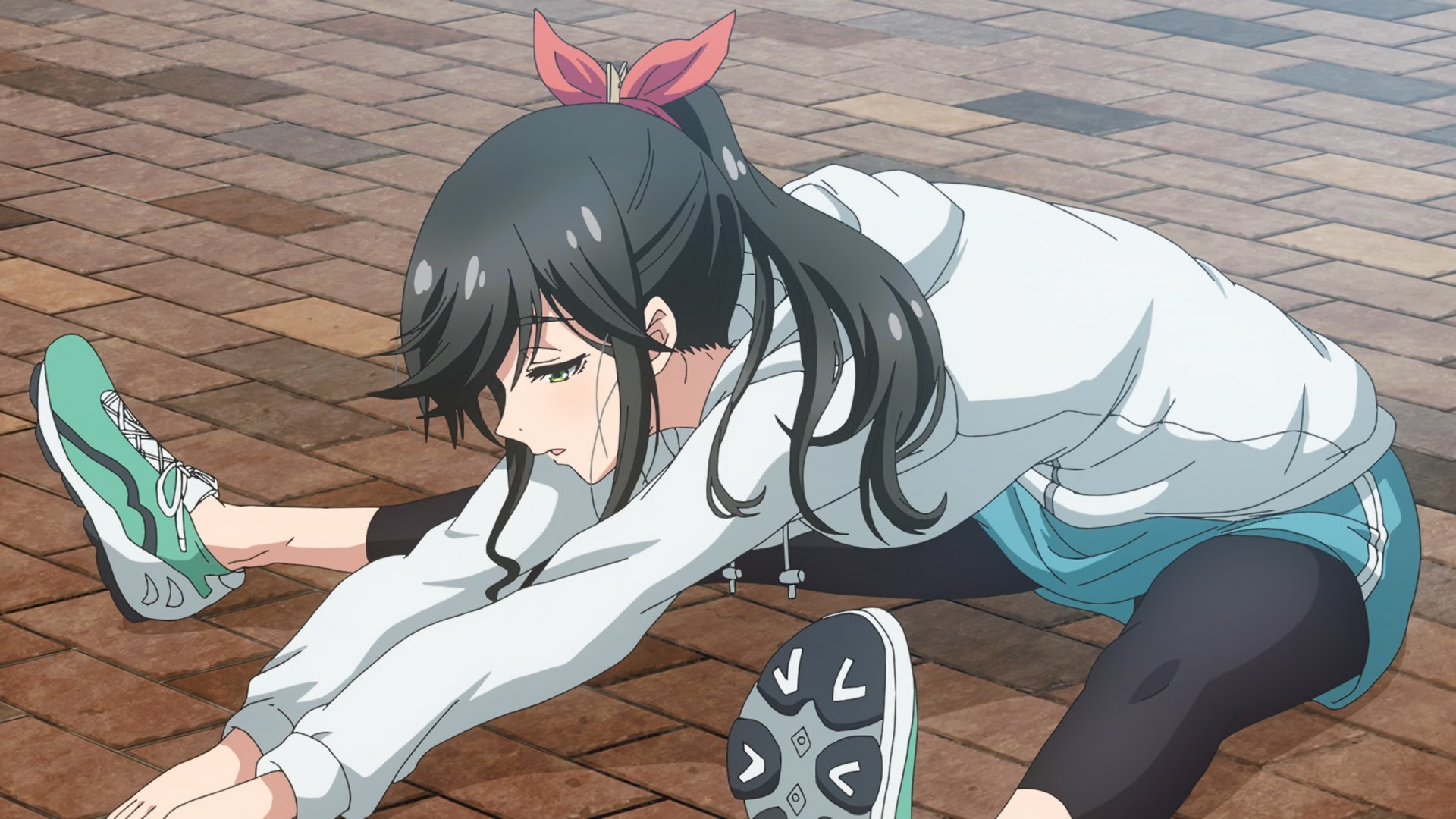 Kinme stretching out, doing a split, wearuing a jogging suit and her long black hair in a ponytail.
